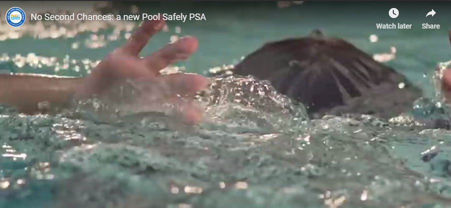 A swimmer with their head under water and their hands above water.